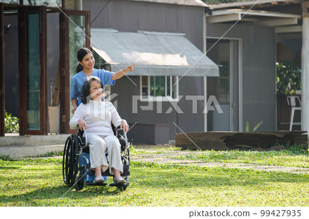 Elderly asian senior woman on wheelchair with nurse. Nursing home hospital garden concept. 99427935