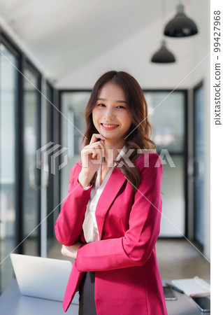 Beautiful asian business woman working at office. Financial analysis and tax concept.. 99427968