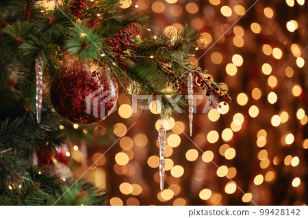 A branch of a Christmas tree decorated with New Year A branch of a Christmas tree decorated with New Year 99428142