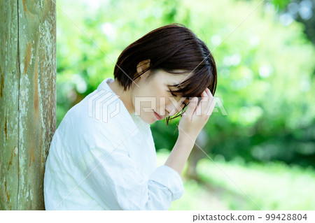Depressed woman who came to a fresh green park for a change 99428804