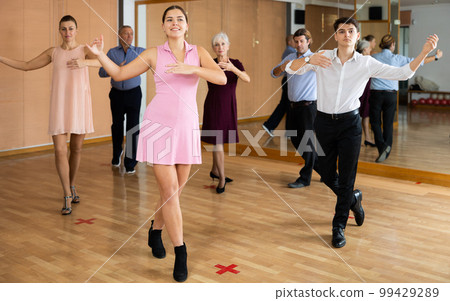 Young happy couple performing a paired dance in ballroom 99429289