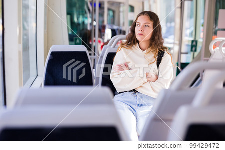 Portrait of a focused girl riding on public transport Portrait of a focused girl riding on public transport 99429472