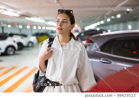 Portrait of woman on underground parking 99429523