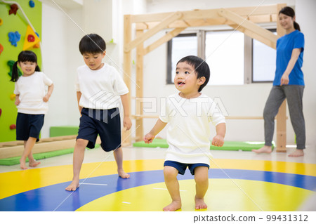 cute toddler dancing and doing gymnastics 99431312