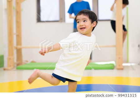 cute toddler dancing and doing gymnastics 99431315