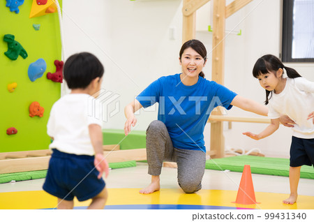 Children exercising in nursery school or kindergarten 99431340