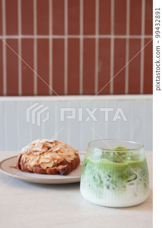 Ice matcha green tea served with croissant 99432891