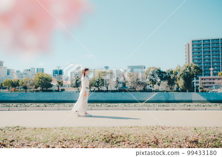 Photo of a young woman walking along a riverbed Photo of a young woman walking along a riverbed 99433180