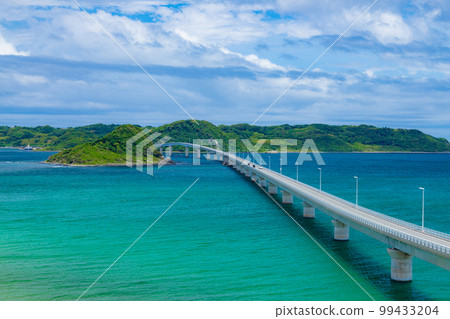 Tsunoshima Ohashi Bridge stretches over the beautiful cobalt blue sea 99433204