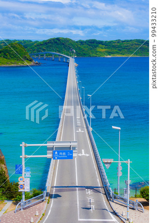Tsunoshima Ohashi Bridge stretches over the beautiful cobalt blue sea 99433210