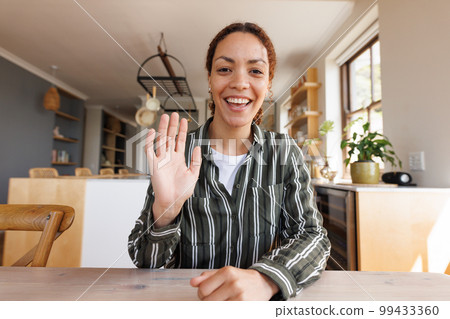 Happy biracial woman having video call 99433360