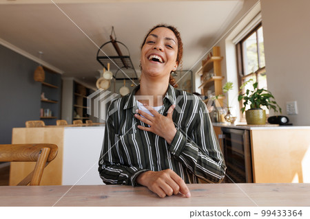 Happy biracial woman having video call 99433364