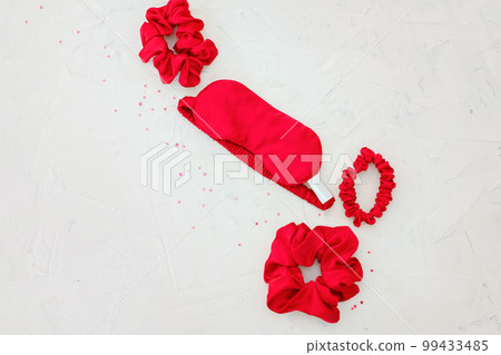 top view red accessories sleeping mask on grey background top view red accessories sleeping mask on grey background 99433485
