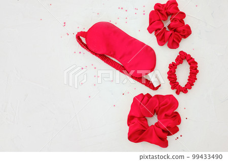 top view red accessories sleeping mask on grey background top view red accessories sleeping mask on grey background 99433490