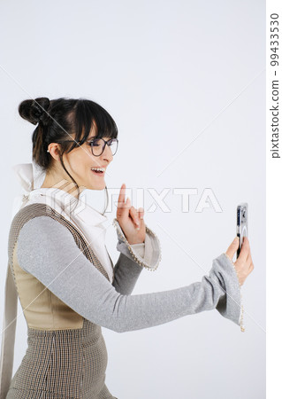 Selective focus woman with cell phone white background Selective focus woman with cell phone white background 99433530