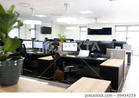 Open space office with desks, chairs and computers 99434259