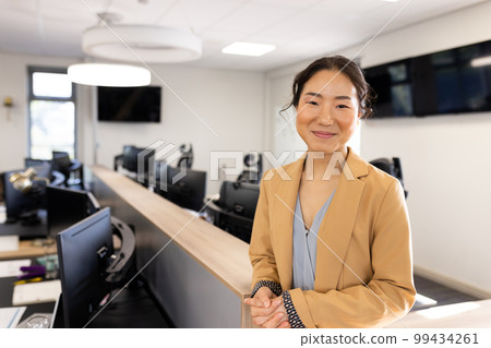 Happy asian businesswoman looking at camera in office 99434261