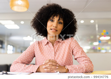 Image of biracial woman having video call on laptop in office Image of biracial woman having video call on laptop in office 99434776