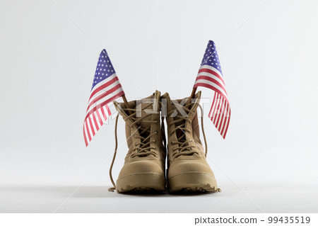 Military boots with flags of usa on white background, with copy space 99435519