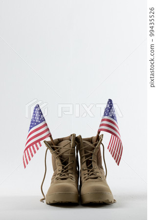 Military boots with flags of usa on white background, with copy space Military boots with flags of usa on white background, with copy space 99435526