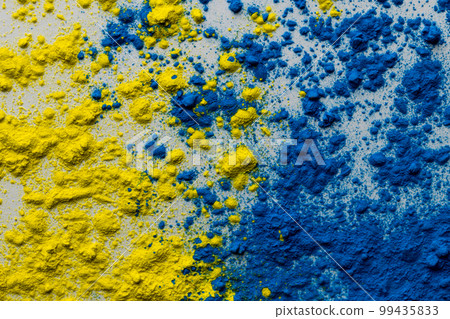 Close up of yellow and blue coloured powder with copy space 99435833