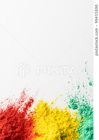 Close up of multi coloured powder and copy space on white background 99435898