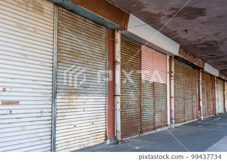 Uninhabited shopping street with closed shops Uninhabited shopping street with closed shops 99437734