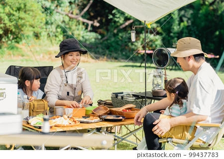 Family eating barbecue and camping rice at the campsite (outdoor, travel, leisure, picnic) 99437783