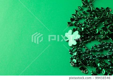 Image of green clover and jewellery and copy space on green background Image of green clover and jewellery and copy space on green background 99438546