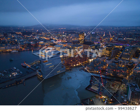 Aerial view of Oslo Downtown Skyline, Norway. Financial district and business centers in smart urban city in Europe. Skyscraper and high-rise buildings at night. 99438627