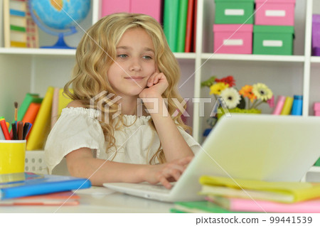 girl using laptop at desk at home 99441539