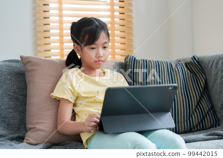 Asian little girl happy smile using tablet. Asian little girl happy smile using tablet. 99442015