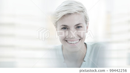 Composition of happy caucasian busineswoman looking at camera and smiling with double exposure Composition of happy caucasian busineswoman looking at camera and smiling with double exposure 99442256