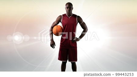 Composition of male basketball player holding basketball with copy space Composition of male basketball player holding basketball with copy space 99443253