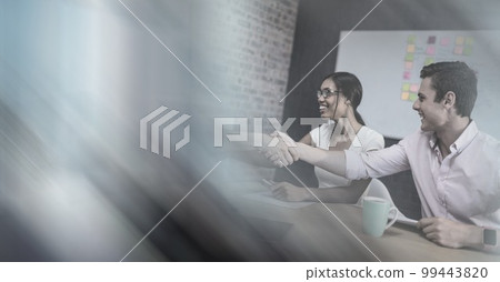 Composition of happy diverse business team shaking hands with motion blur 99443820