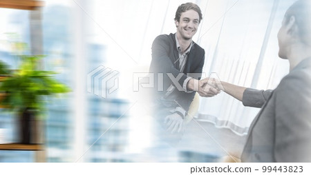 Composition of two happy diverse businesspeople shaking hands with motion blur Composition of two happy diverse businesspeople shaking hands with motion blur 99443823