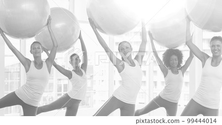 Composition of group of happy women exercising with swiss balls in fitness class in black and white 99444014
