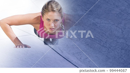 Composition of fit caucasian woman doing press ups in gym with blue blur 99444087