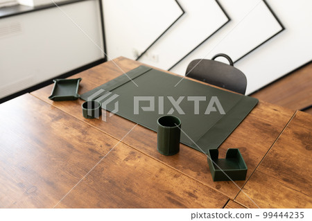 empty workplace in the office with leather green stationery accessories empty workplace in the office with leather green stationery accessories 99444235