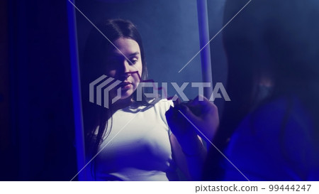 Young woman calling the Queen of Spades 99444247