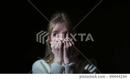 The girl covers her face with her hands in fear The girl covers her face with her hands in fear 99444294
