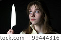 Maniac killer pursuing beautiful young woman with knife, attack on defenceless victim 99444316
