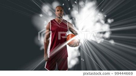 Composition of male basketball player holding basketball with copy space Composition of male basketball player holding basketball with copy space 99444669