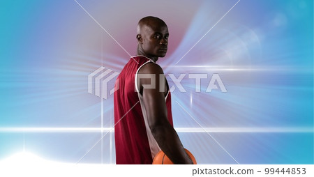 Composition of male basketball player holding basketball with copy space 99444853