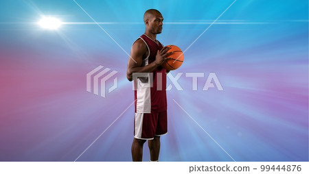 Composition of male basketball player holding basketball with copy space 99444876