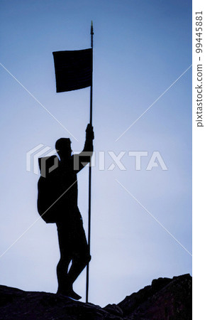 silhouette of man climbing to the top 99445881