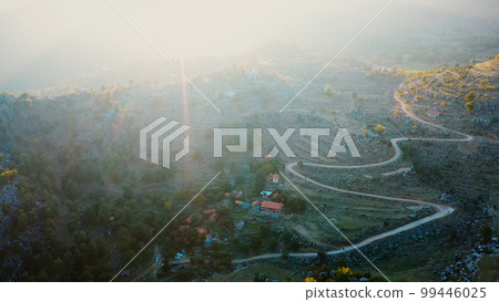 Aerial drone view of mountain valley with beautiful rock formations. Drone view of mountain valley village in the morning. Aerial drone view of mountain valley with beautiful rock formations. Drone view of mountain valley village in the morning. 99446025