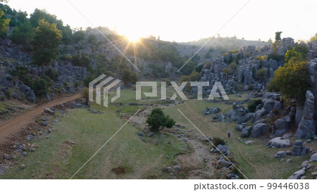 Beautiful aerial view of valley with picturesque rock formations in the morning. Geological background. Ancient city of Selge, Antalya, Turkey. 99446038