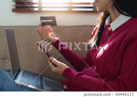 E-Business, Online shopping concept. Asian woman makes a purchase online shopping with credit card. E-Business, Online shopping concept. Asian woman makes a purchase online shopping with credit card. 99446115