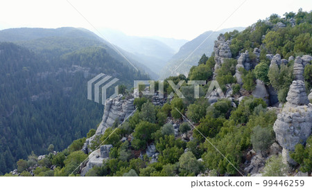 Majestic view of unique rock formations on mountains slopes. Aerial view from drone. Majestic view of unique rock formations on mountains slopes. Aerial view from drone. 99446259